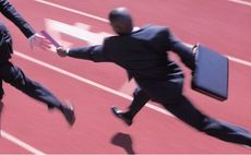 Businessman passing on a baton in a relay race