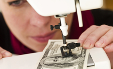 woman-sewing-money