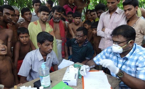 doctor-checking-for-tb-at-a-camp doctor-checking-for-tb-at-a-camp